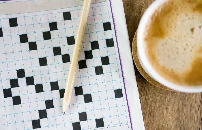 A Crossword Puzzle Game - Tiny Plastic Piece Used To Strum A Guitar