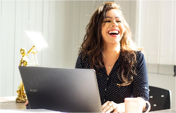 A picture of a confident woman smiling while working for Elijah Norton at Veritas Global Protection